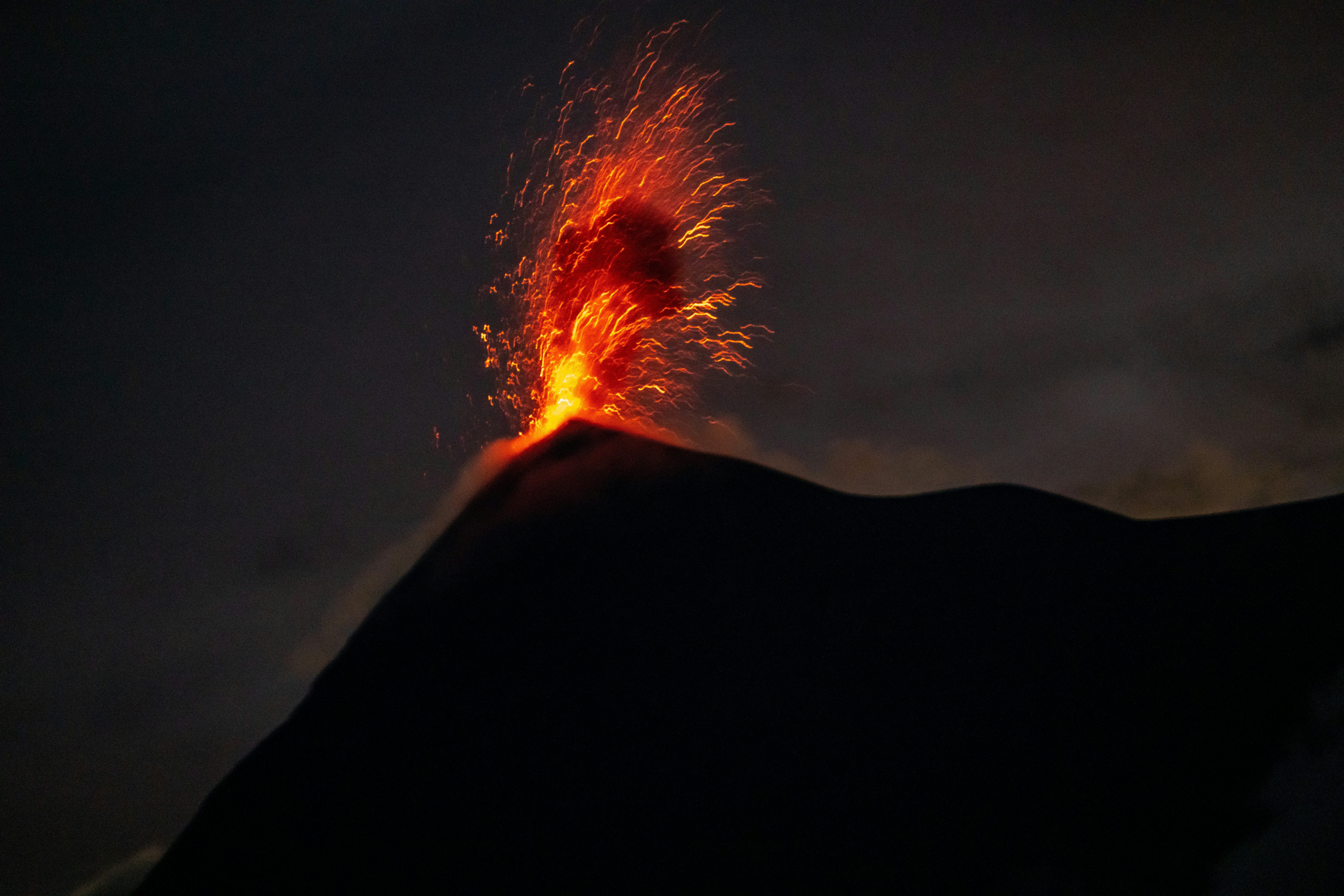 a volcano erupting at night
