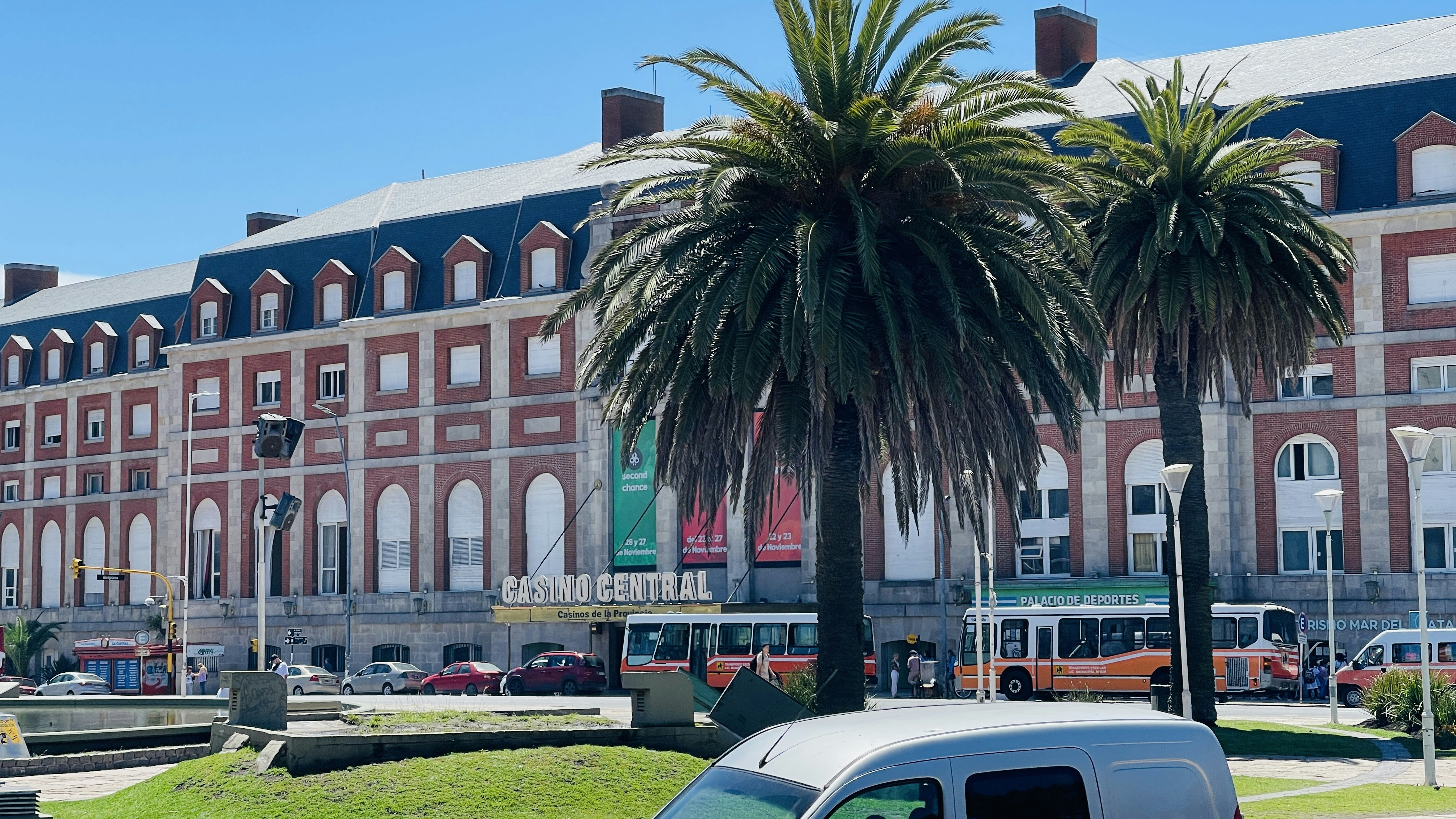 a large building with palm trees in front of it