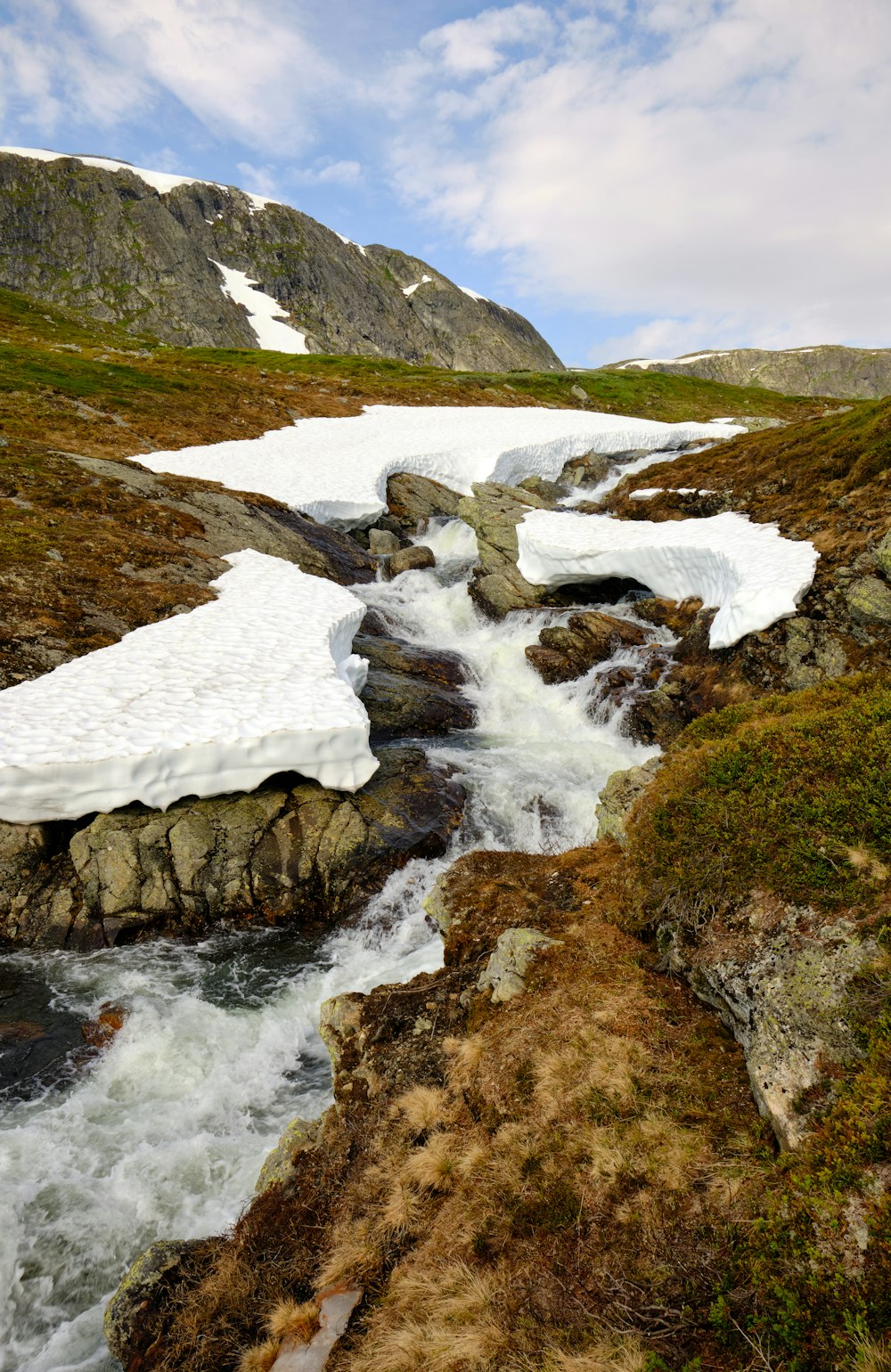 a river running through a snowy mountain