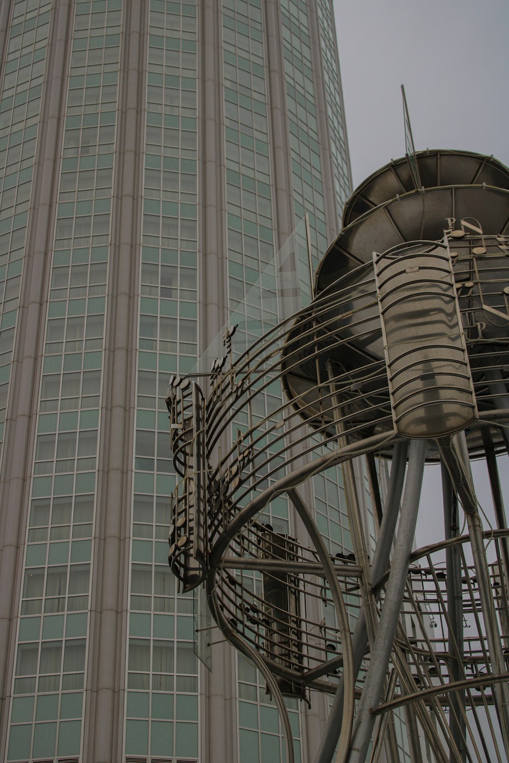 a tall building with a large satellite dish on top