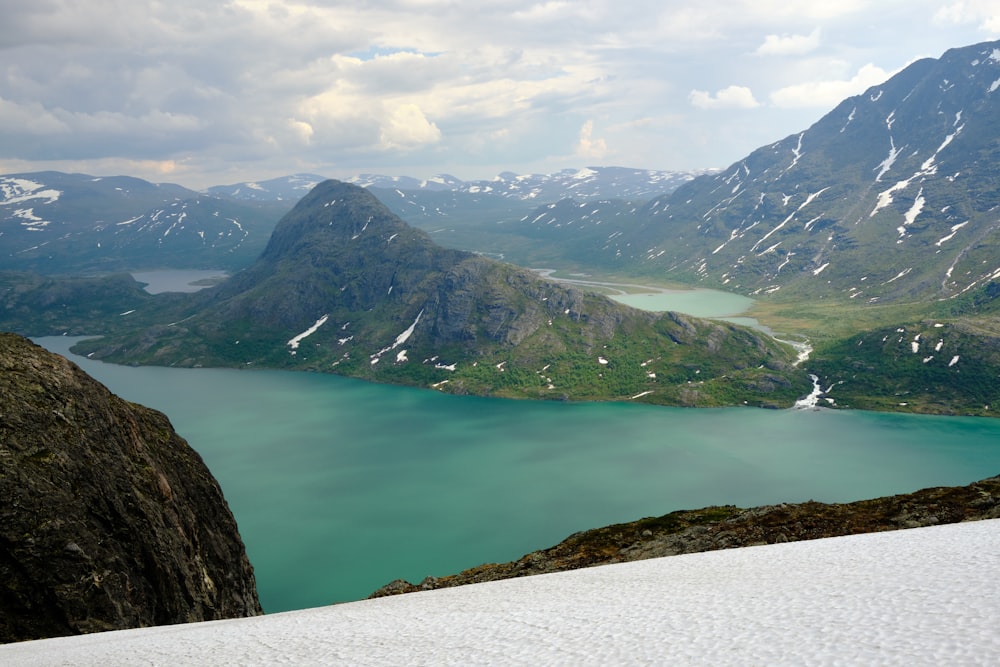 a body of water with mountains in the back