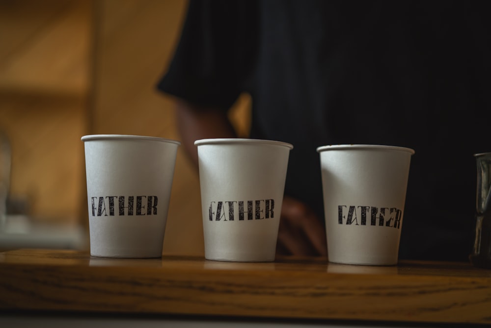 a group of cups with text on them