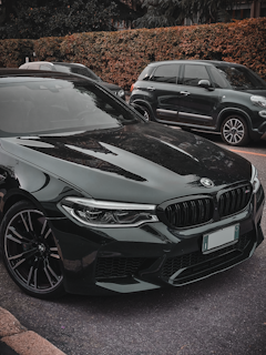 a black car parked next to another car