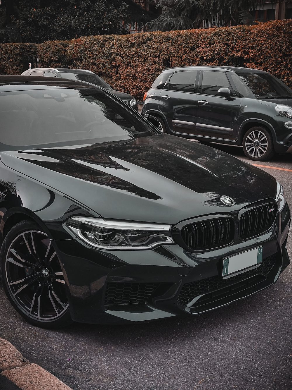 a black car parked next to another car