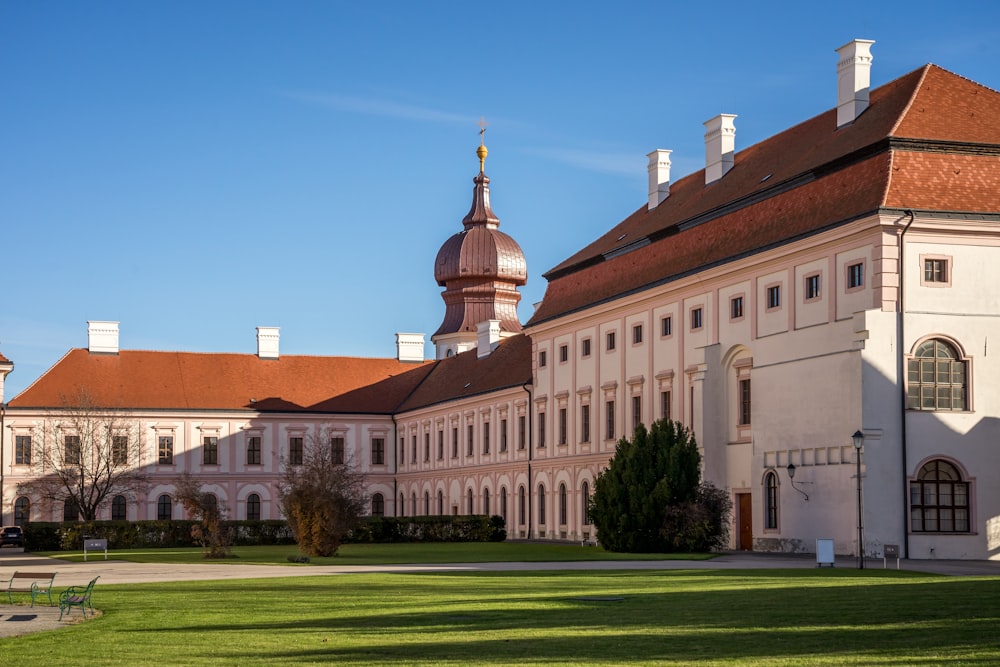 a large building with a lawn in front of it