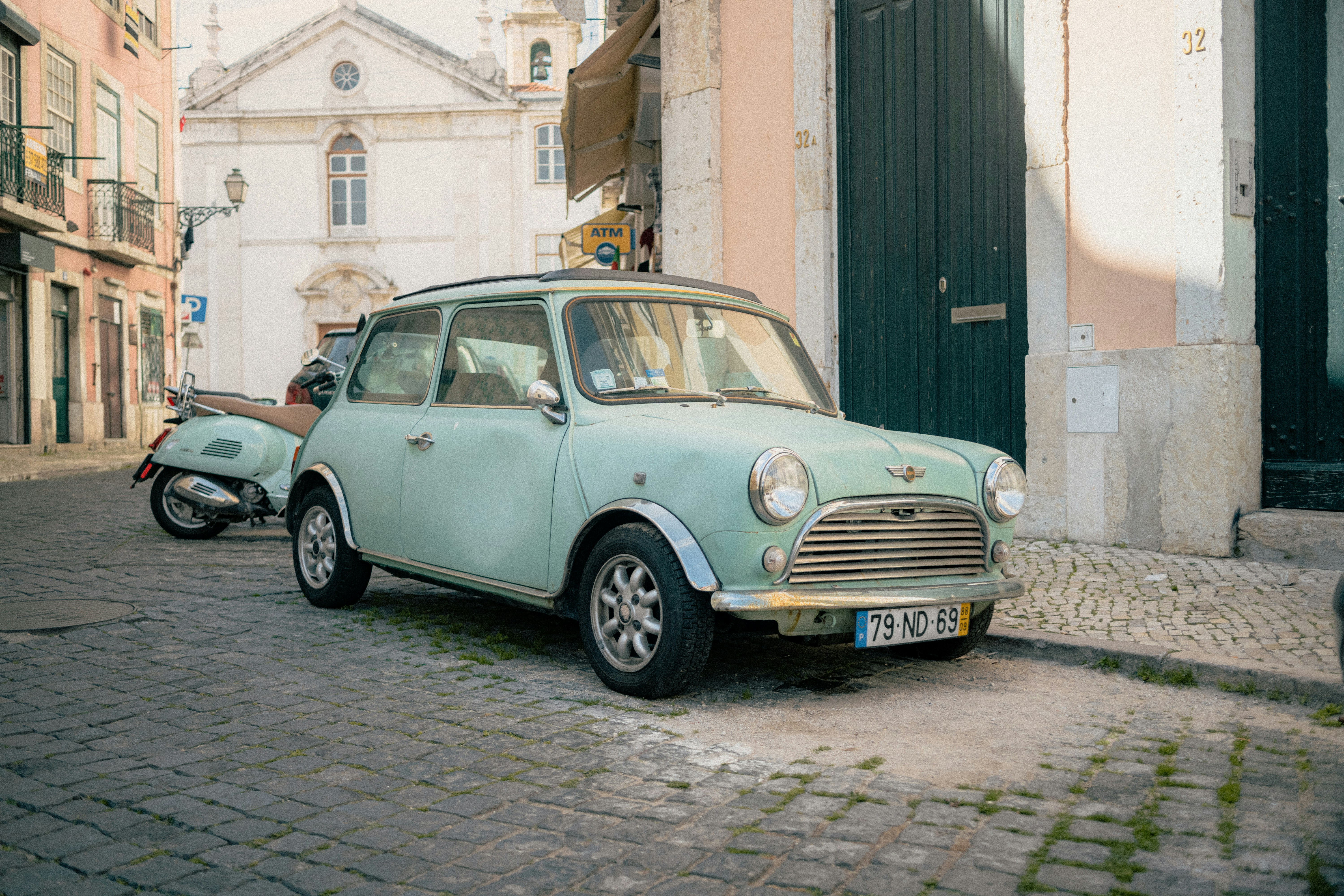 Retro mini sitting in the shadowed backstreets of Lisbon's old town Alfama.
