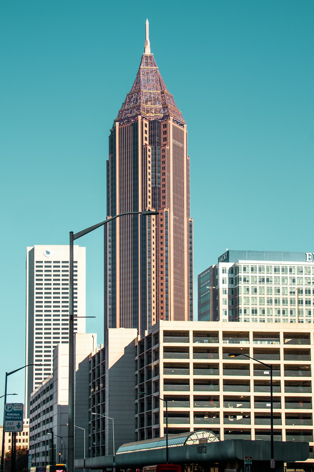 a tall building with a pointy top with Bank of America Plaza in the background