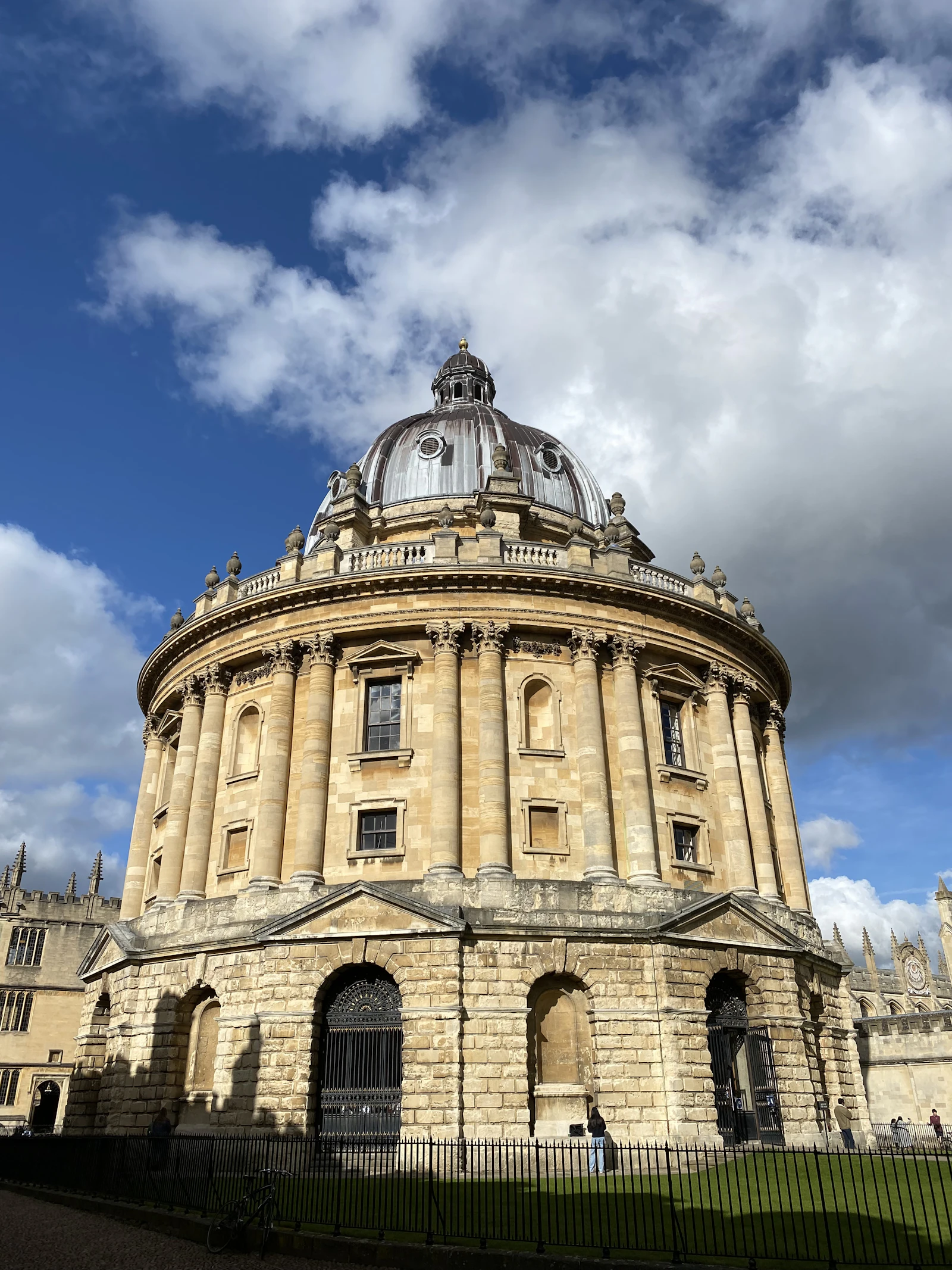 Historic stone university buildings in Oxford with the Bodleian Library in the background