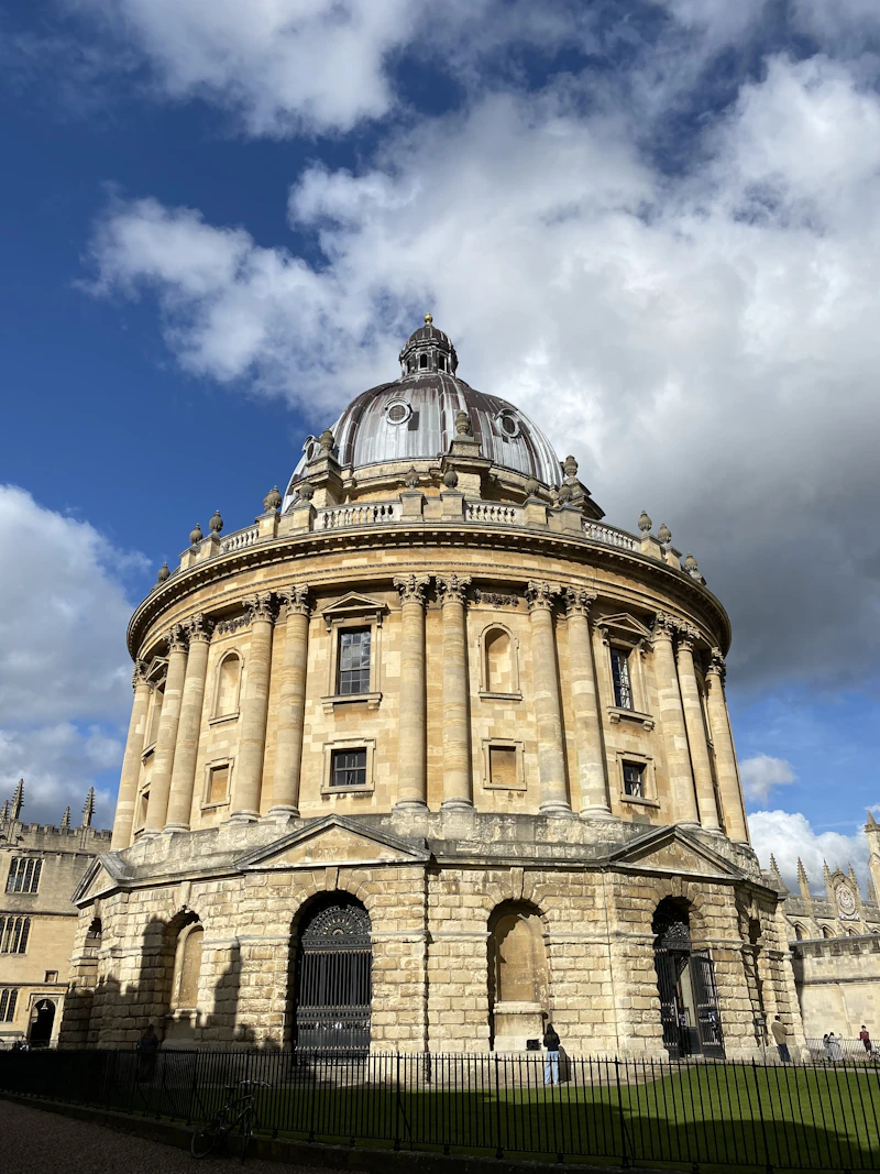 Historic stone university buildings in Oxford with the Bodleian Library in the background