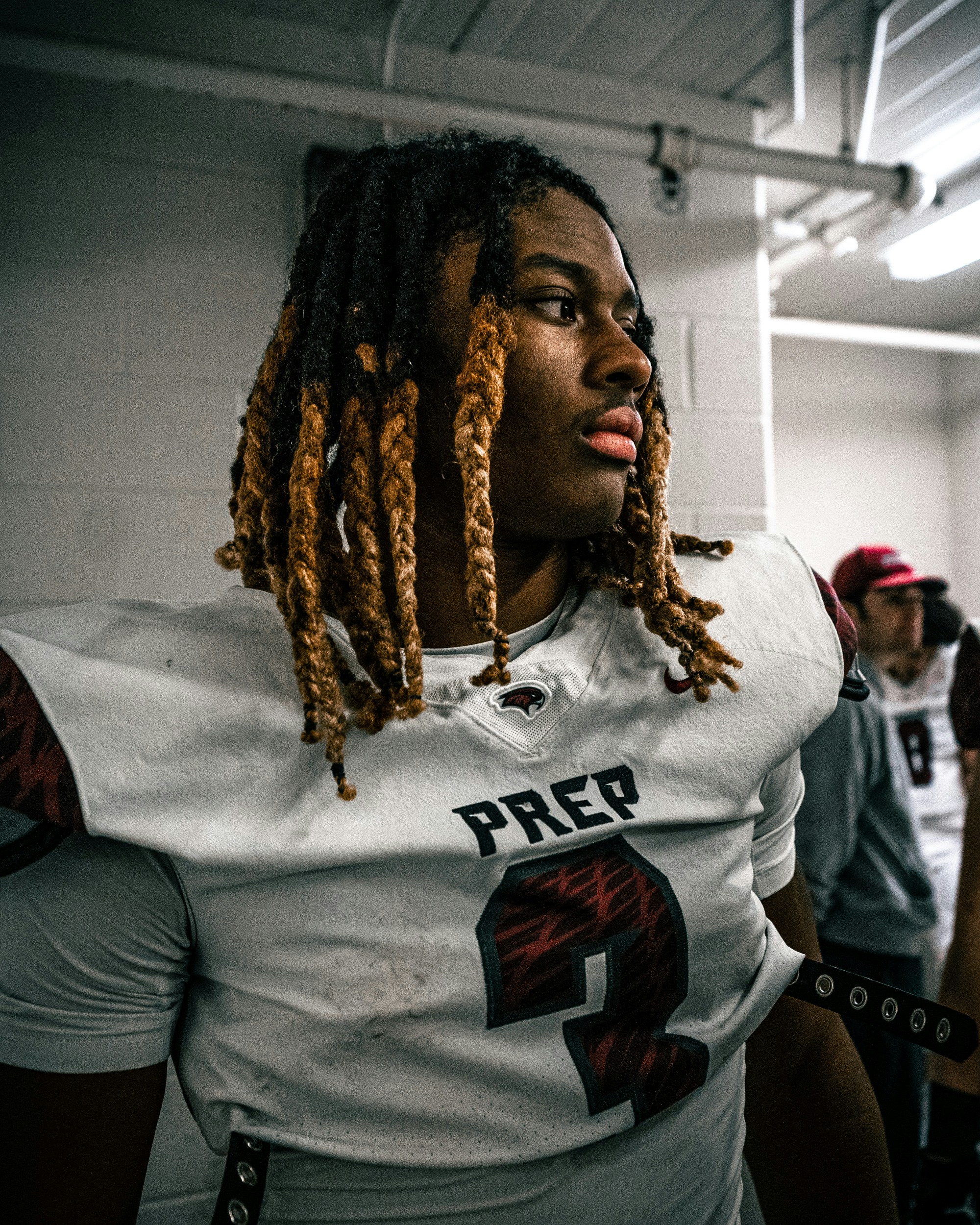 a person with long hair and a microphone in front of him