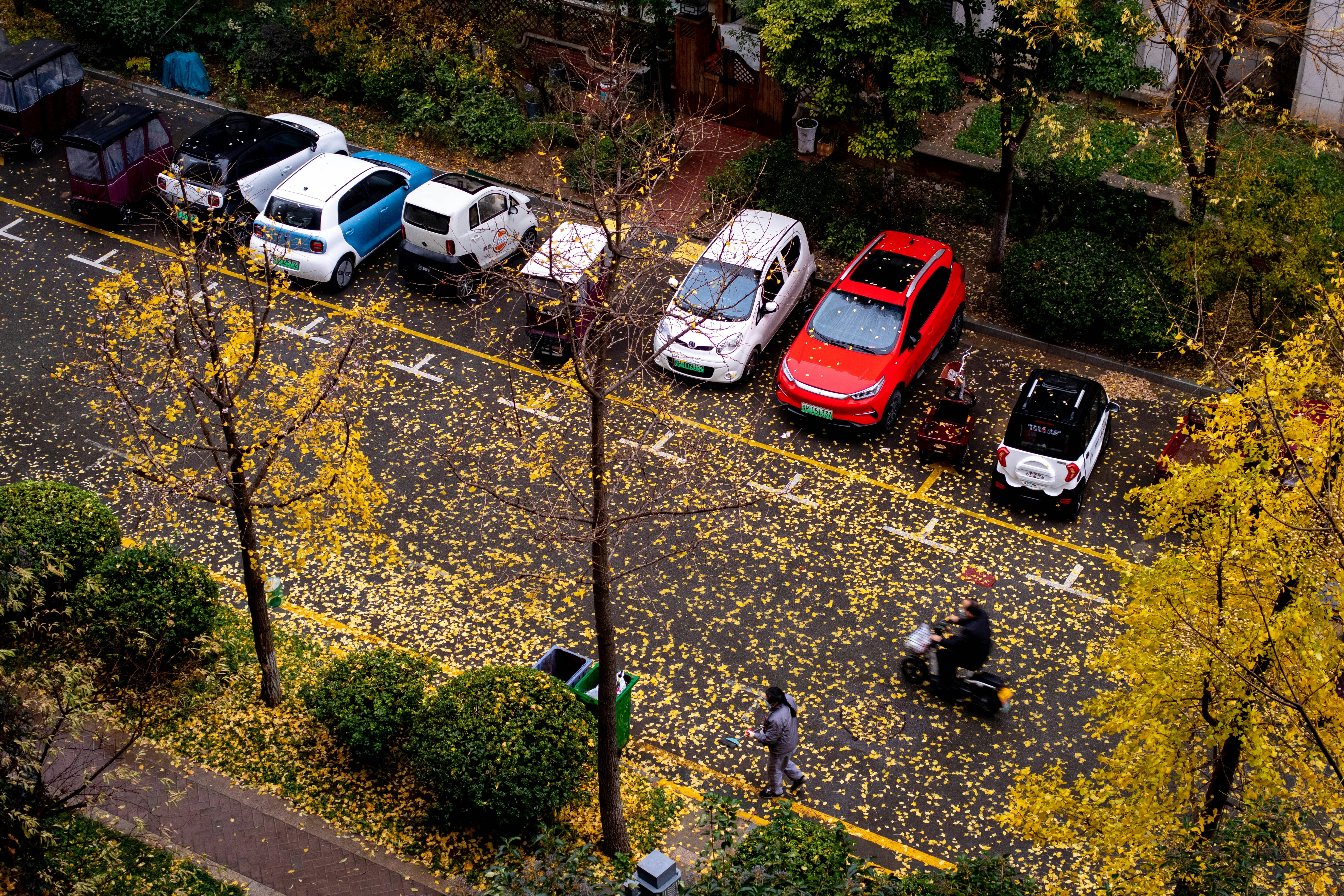Driver carefully parking a small electric car in a tight indoor garage space