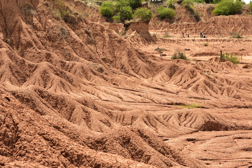 a dirt hill with a few people on it