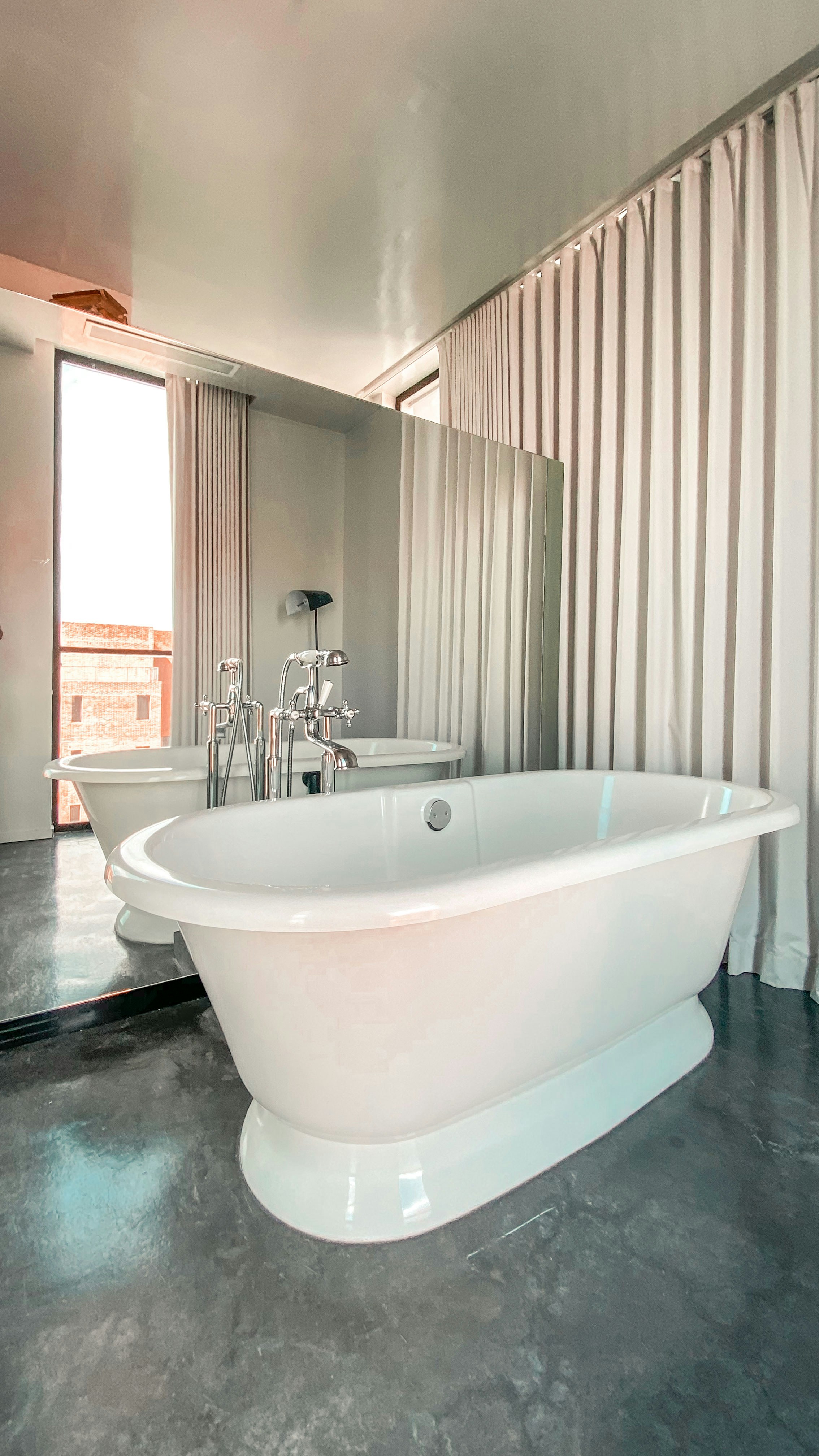 a large white bathtub in a bathroom