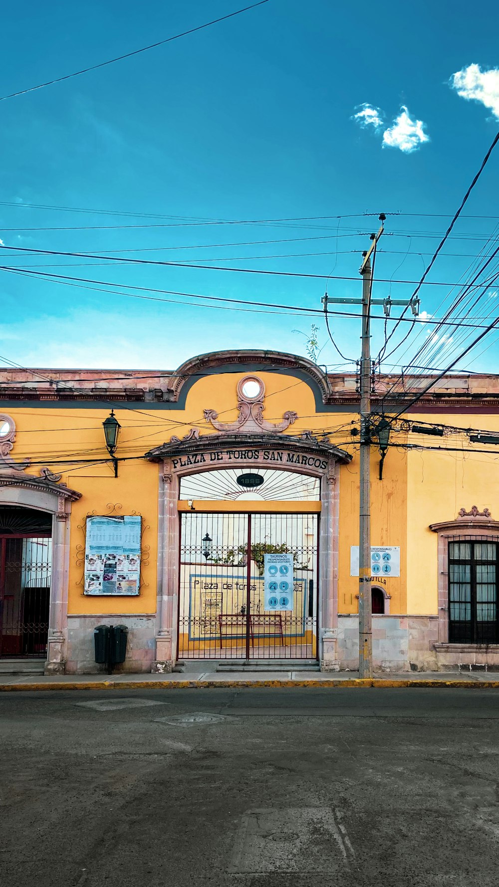 a yellow building with a gate