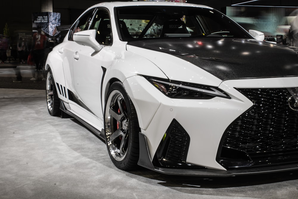 a white car parked in a showroom