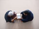 a couple of men looking at a tablet