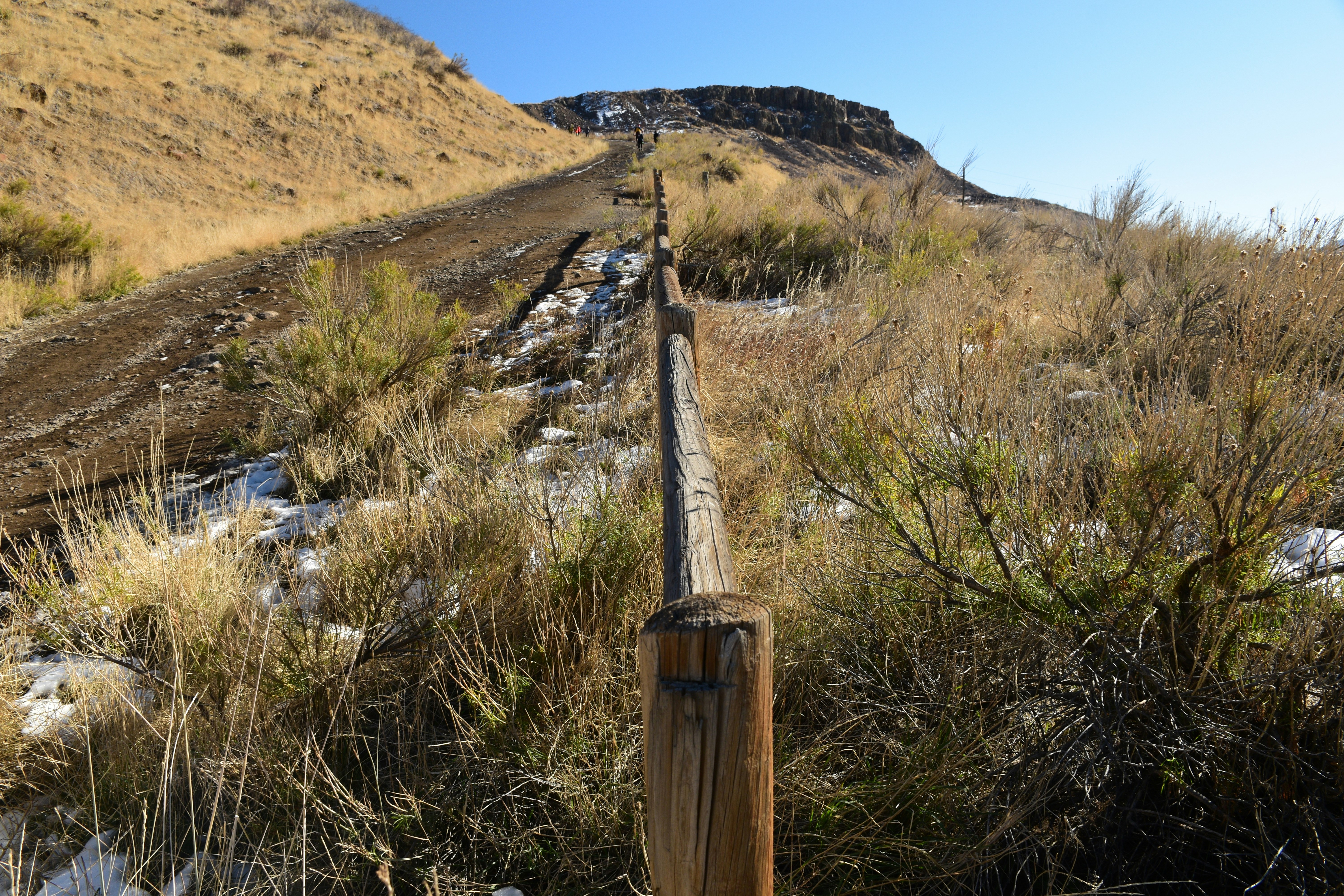 a wooden fence in a field