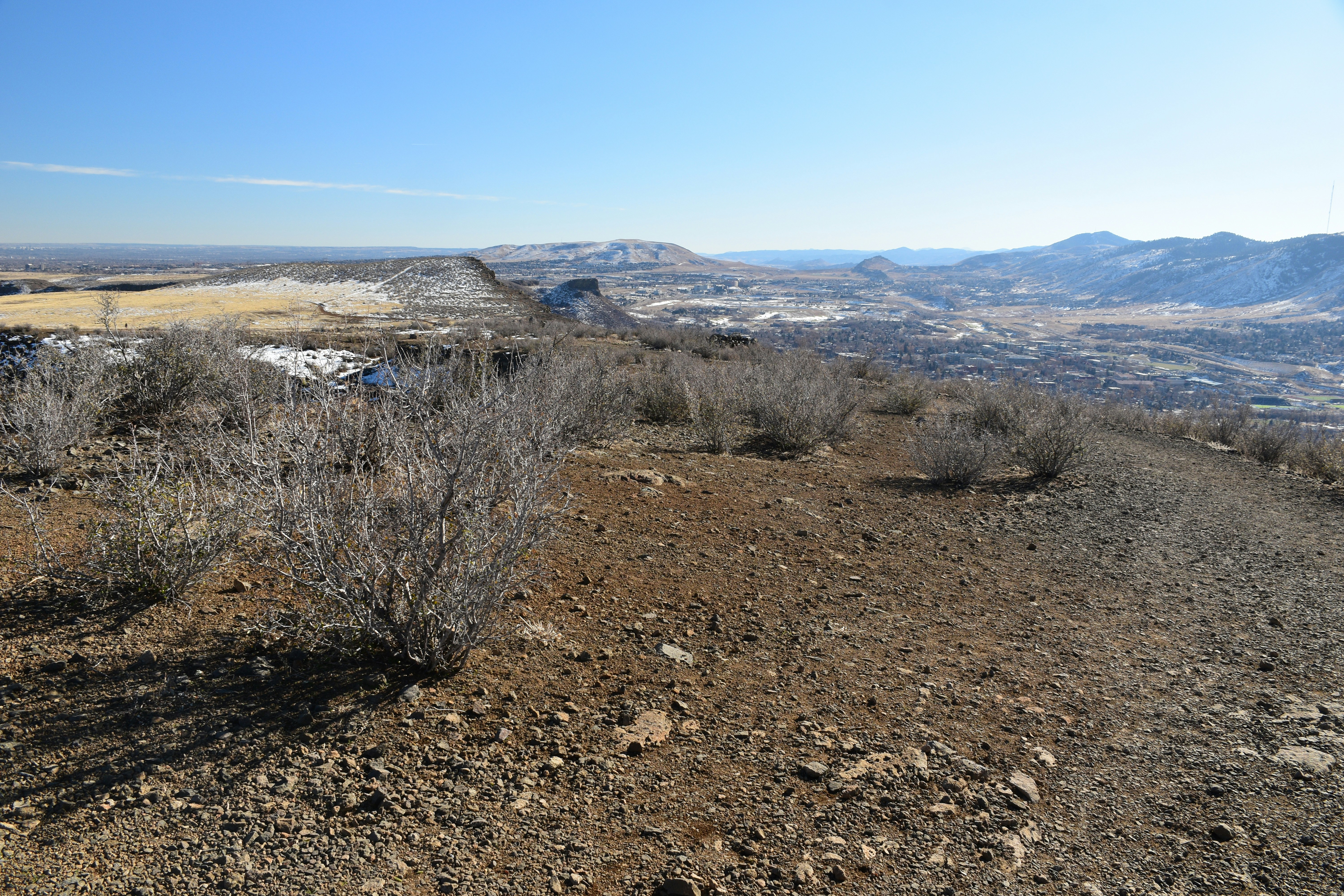 a landscape with dry brush and mountains