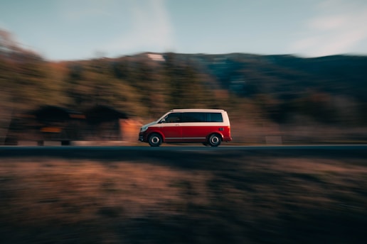 A delivery van speeding on a highway with scenic Chilean landscape in the background.