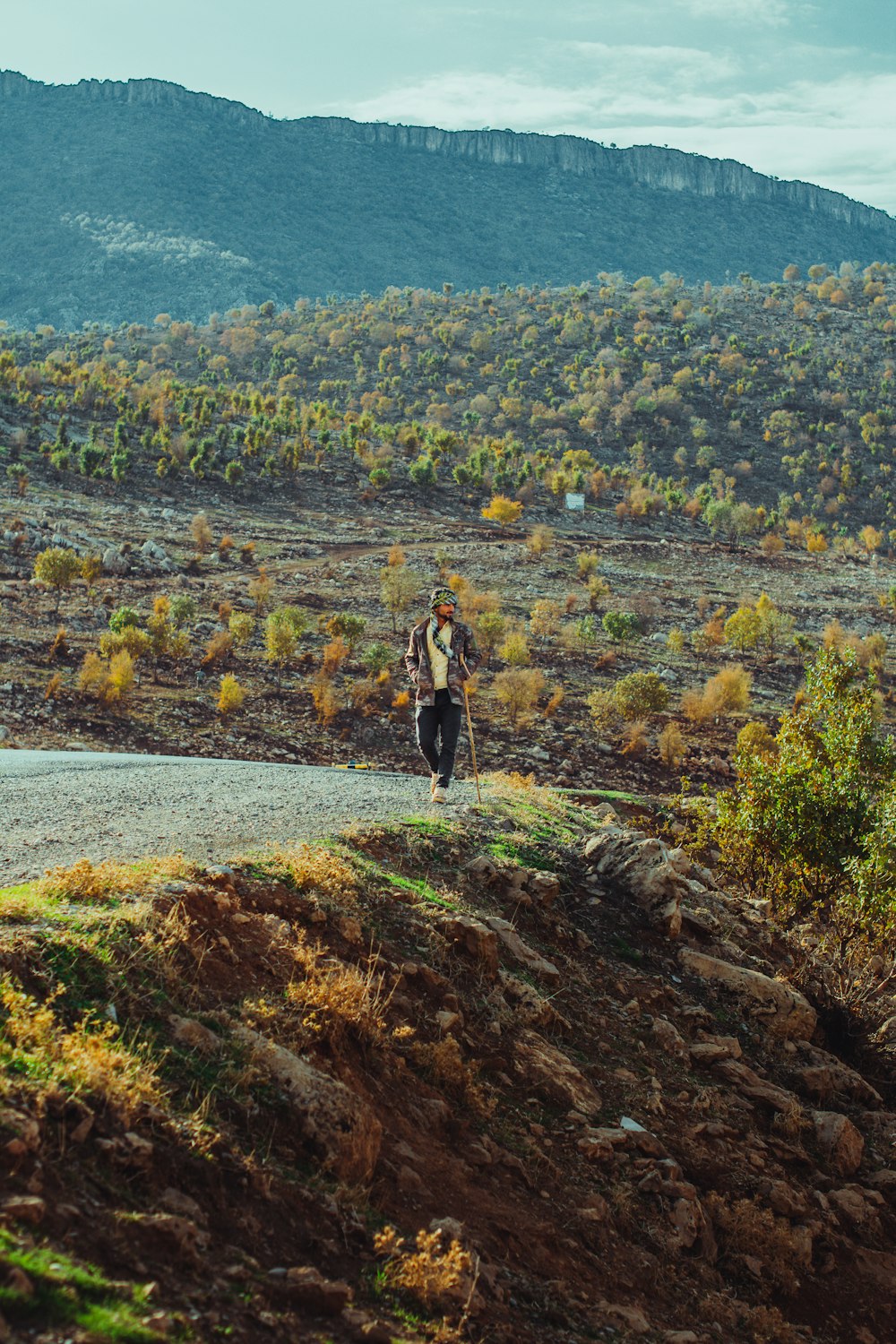 a person standing on a rocky hill