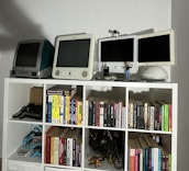 A shelf filled with vintage tech gadgets and engineering books.