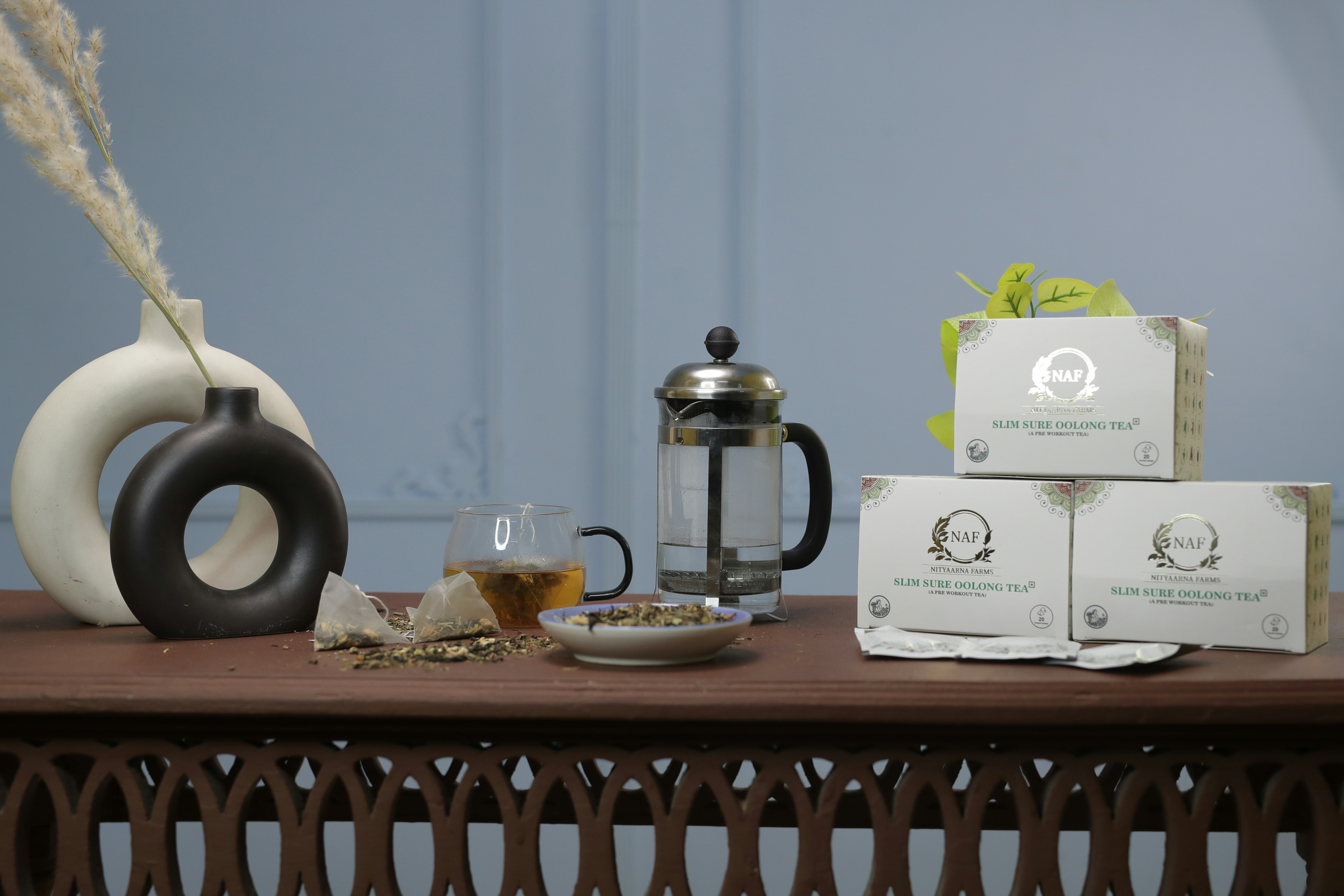 a table with a tea kettle and boxes on it