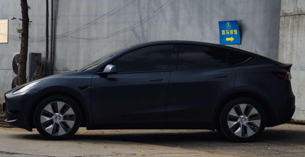 a black car parked on the side of a road