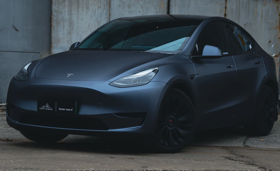 A black Tesla parked inside a garage