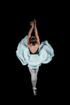 a person dancing in a white dress