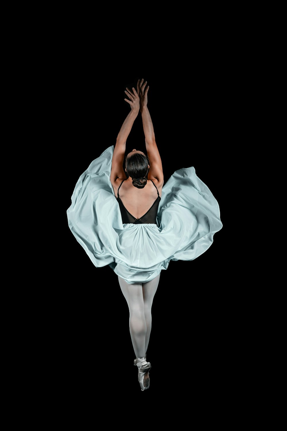 a person dancing in a white dress