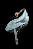 A close-up of a dancer practicing a graceful move.