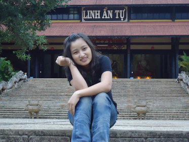 A traveler enjoying a peaceful moment at a historic Vietnamese temple.