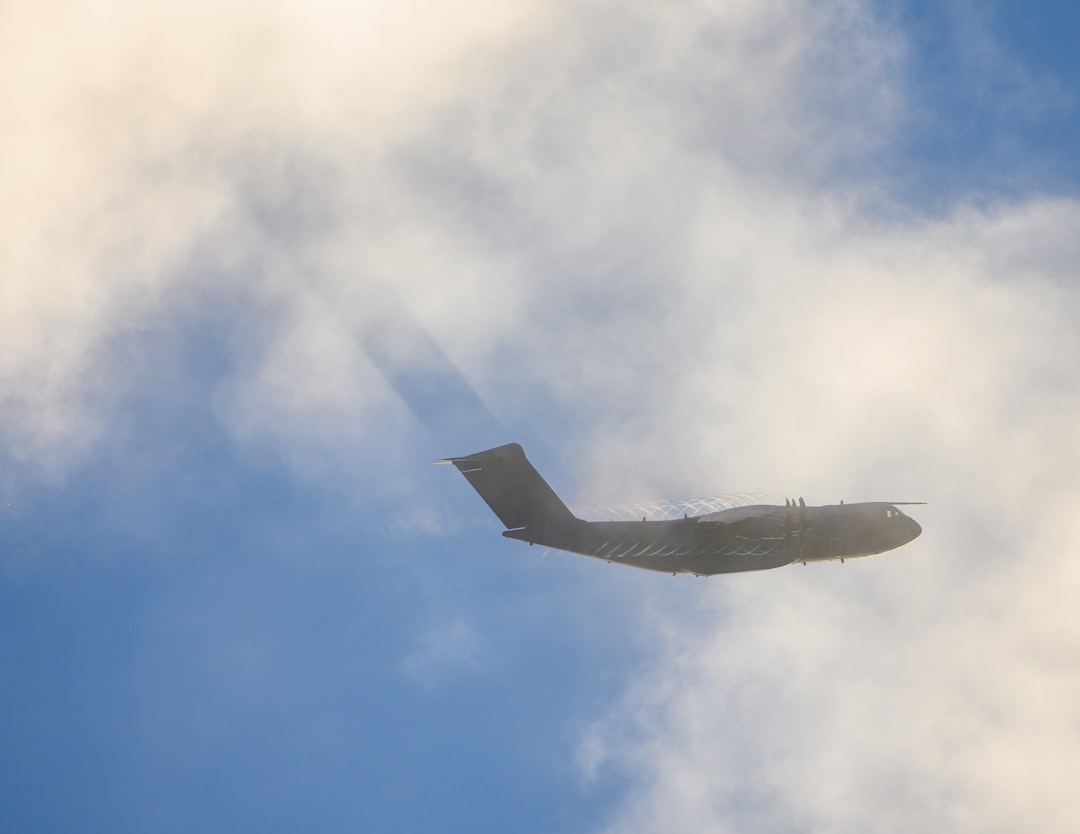 a jet flying in the sky, a400 plane through the clouds