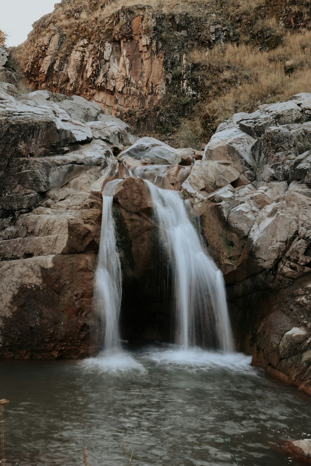 a waterfall over a rocky cliff