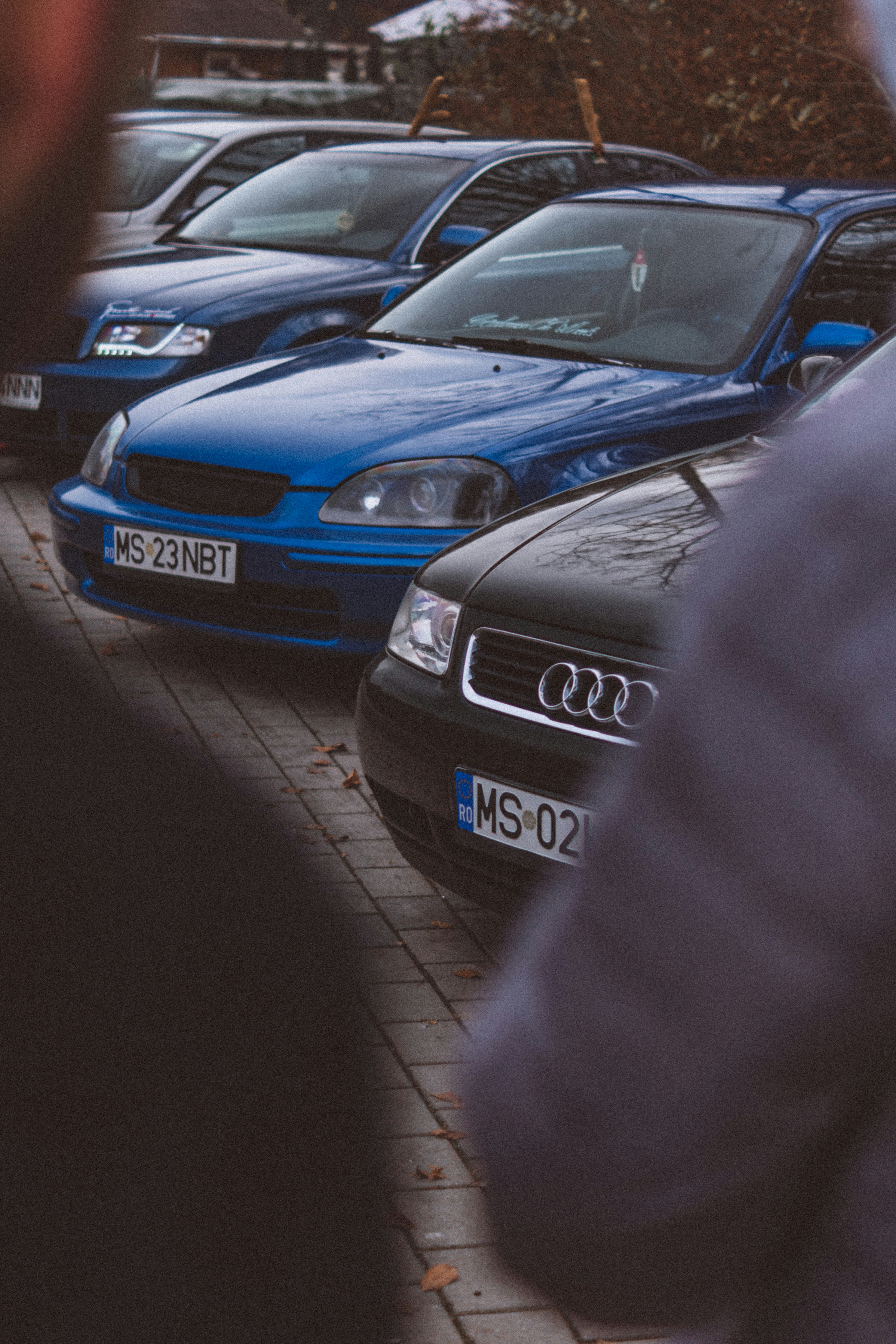 a row of cars parked on the side of a road