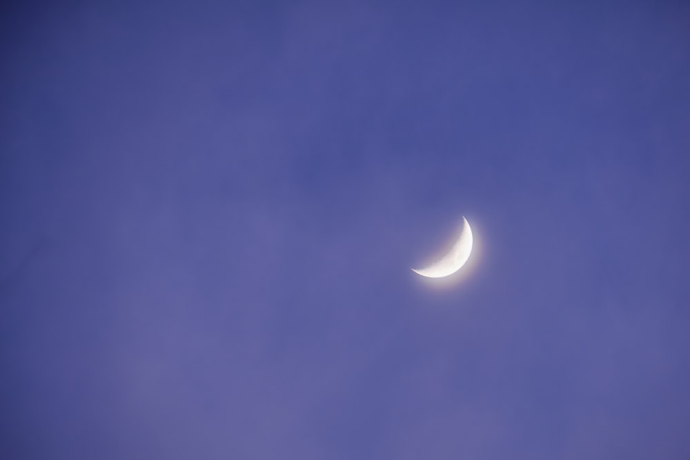 a crescent moon in a blue sky