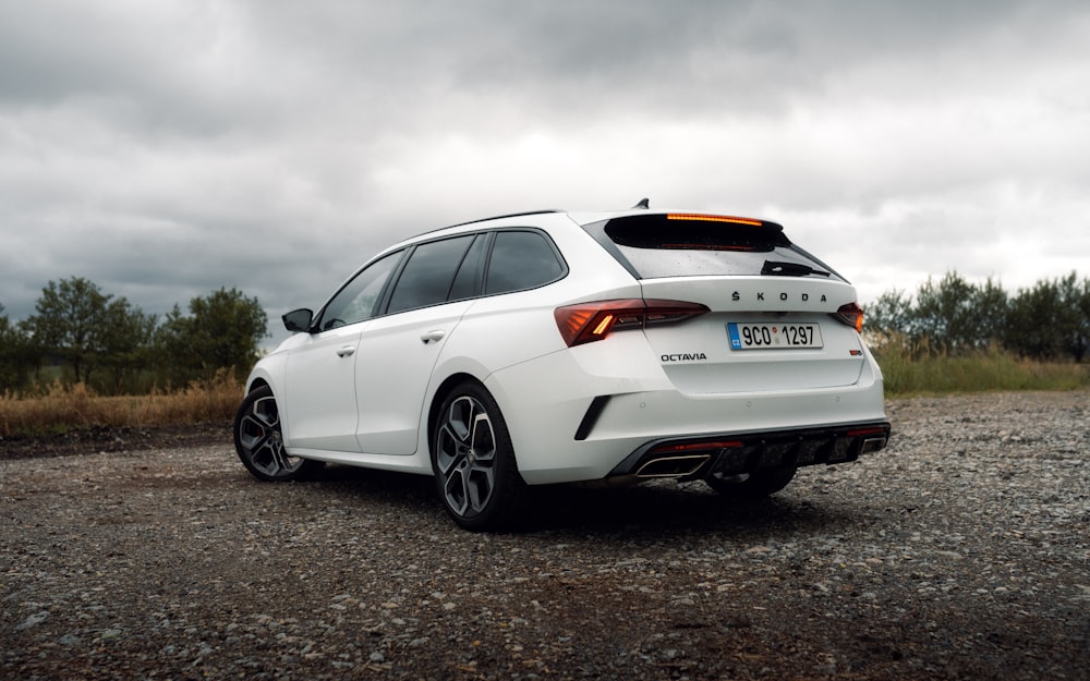 a white car on a gravel road