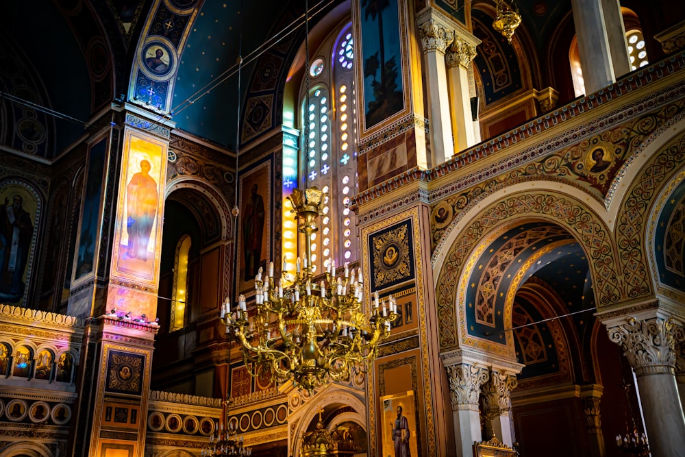 a large ornate chandelier in a large room with stained glass windows