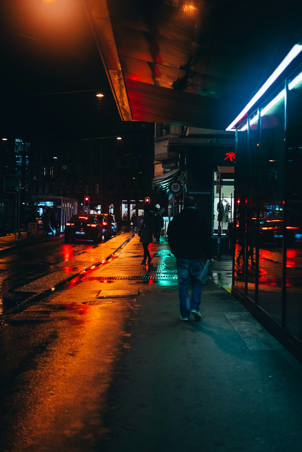 people walking down a sidewalk