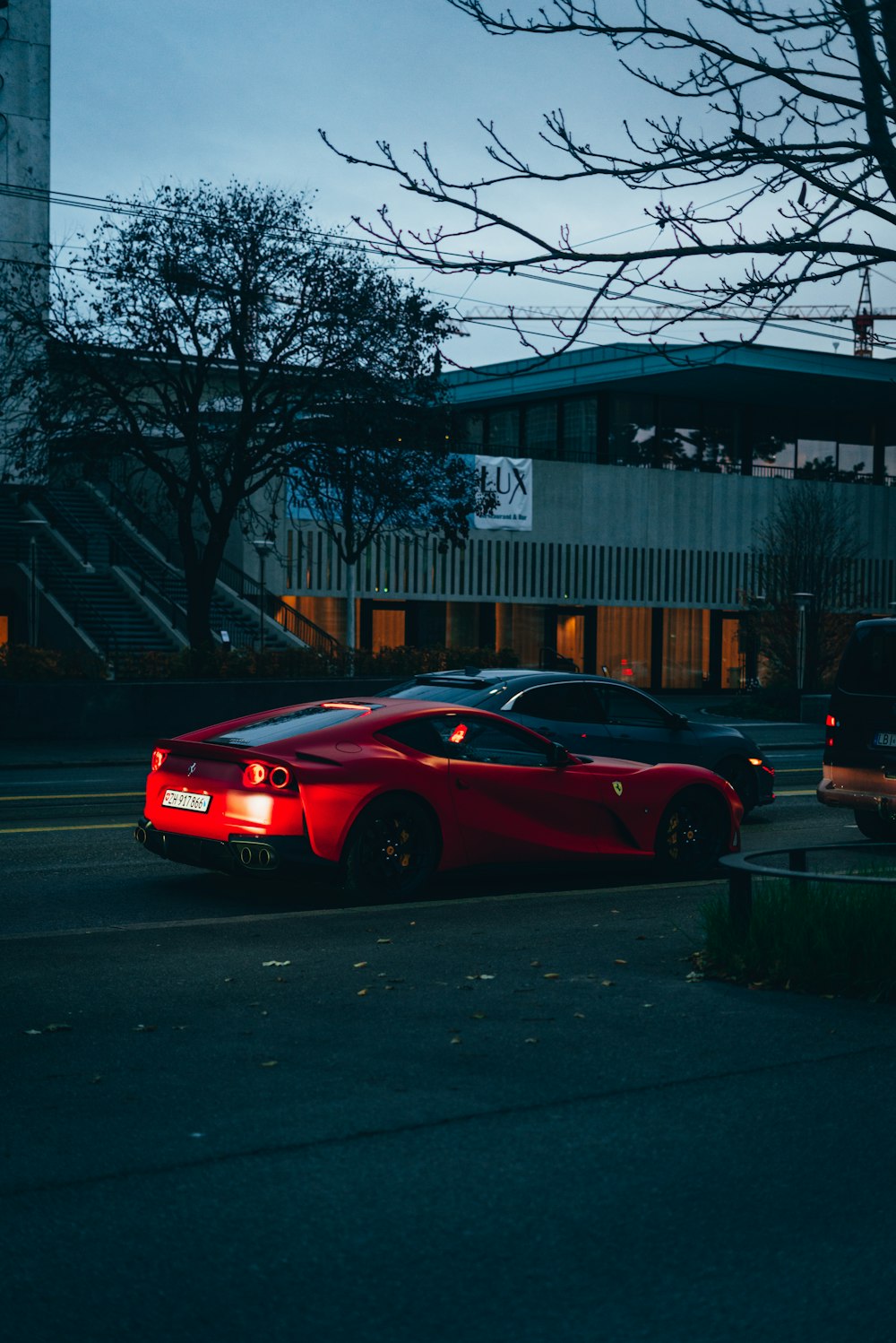 a red car parked in front of a building