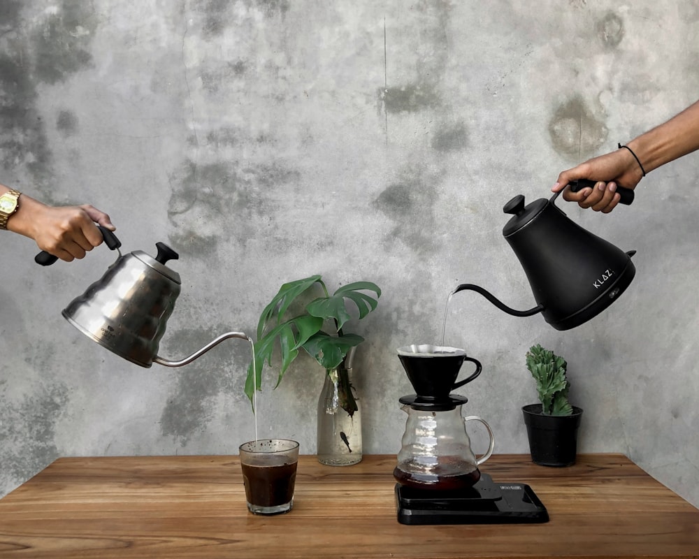 a person pouring liquid into a glass