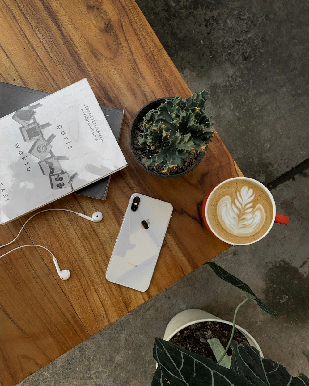 a table with a phone and coffee cups on it