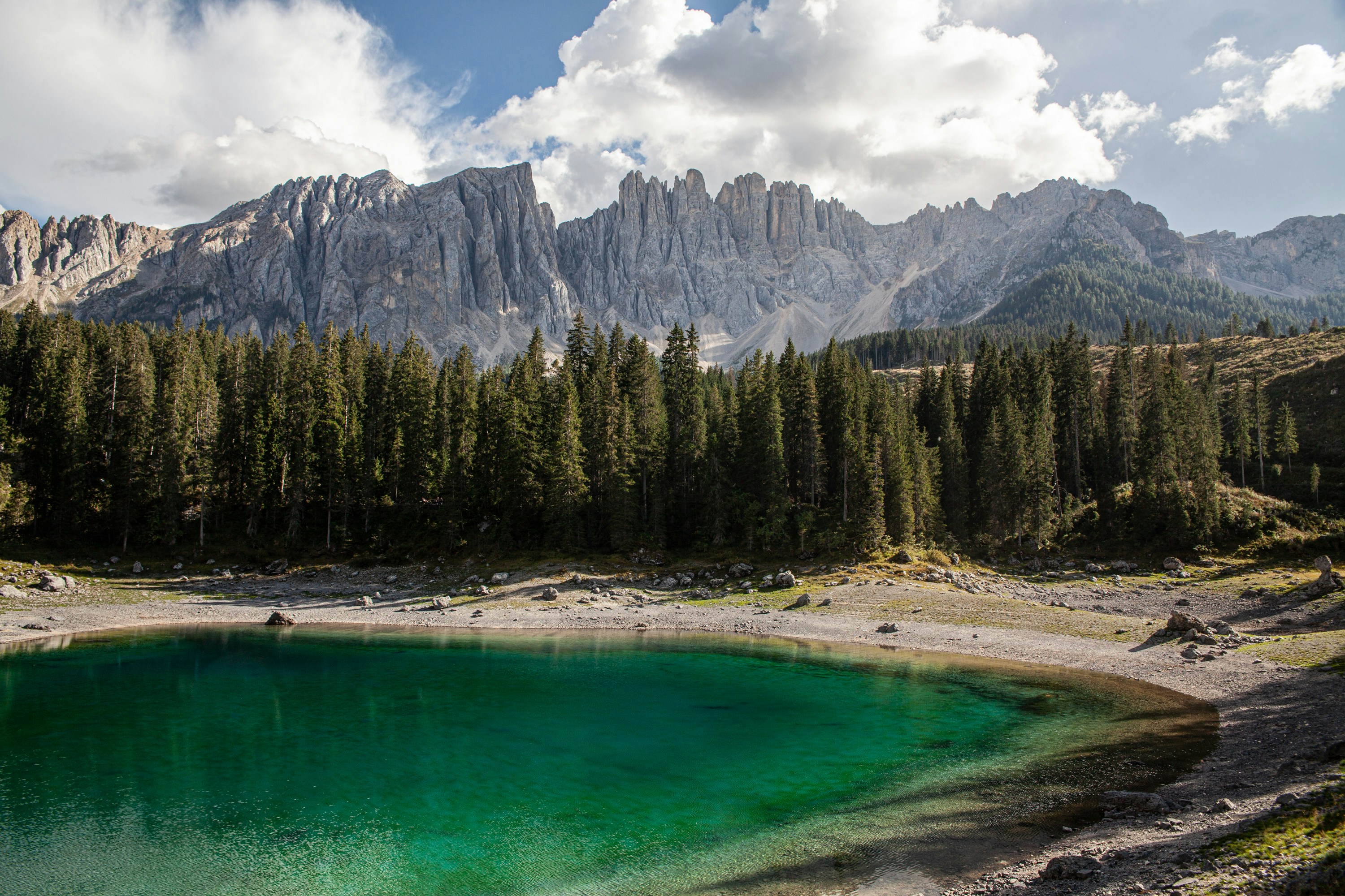a lake with trees and mountains in the background