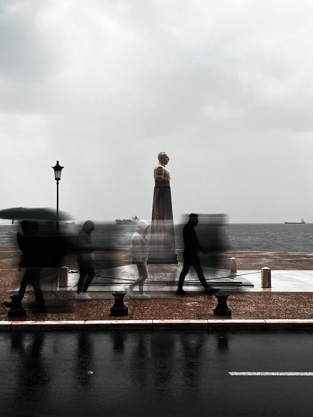 a statue of a person holding an umbrella