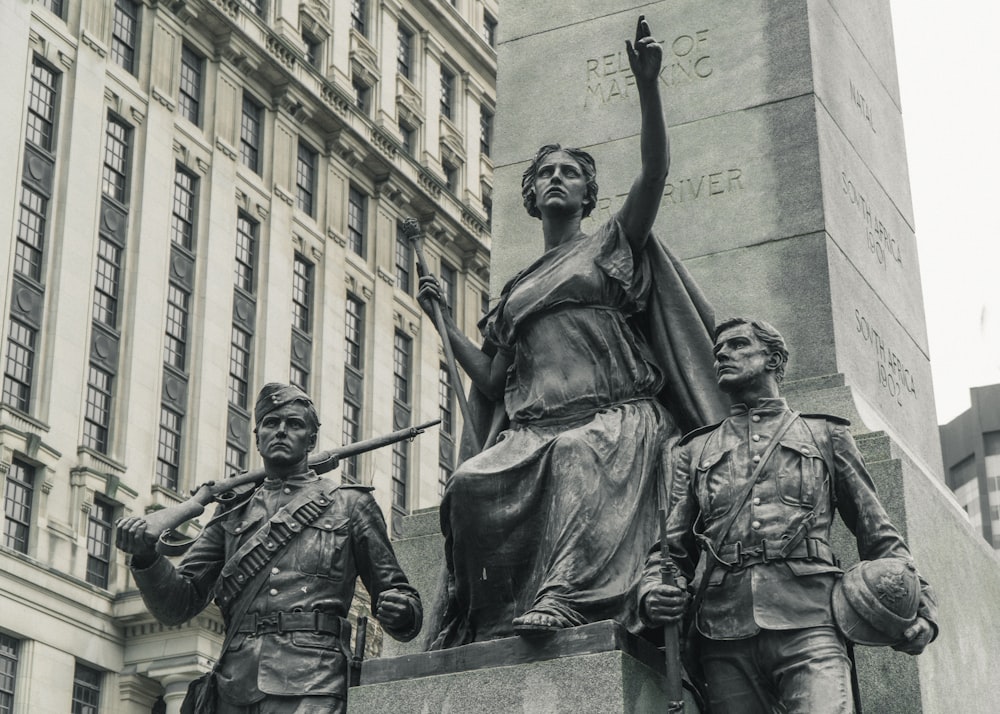 a group of statues in front of a building