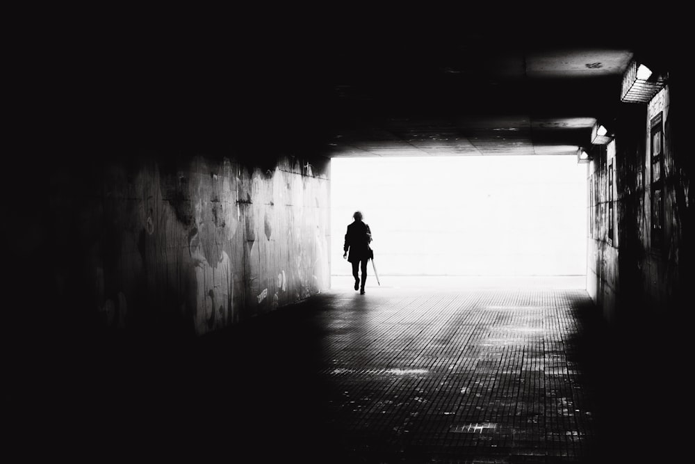 a person walking in a dark alley