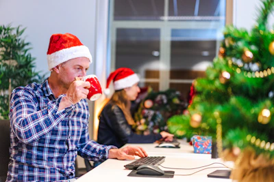 a person in a santa hat drinking from a red cup