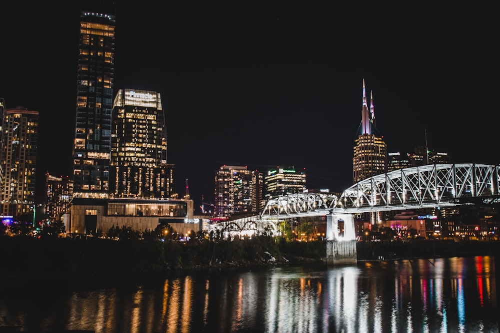 a bridge over a river in a city at night