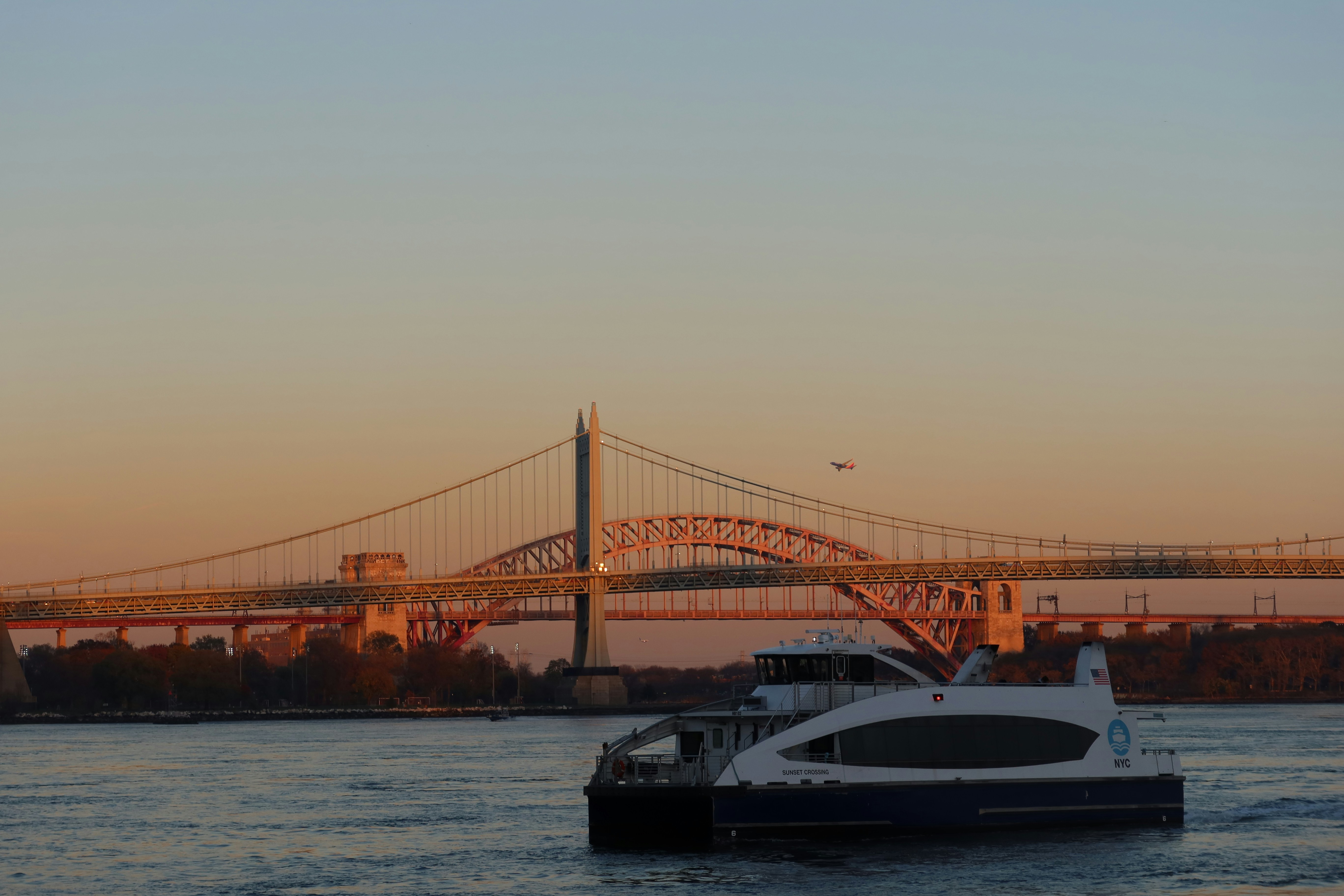 A boat in the water with a bridge in the background