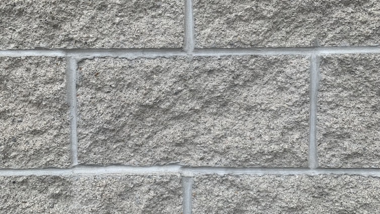 Close-up of gray ICF blocks stacked neatly at a construction site, highlighting texture and material.